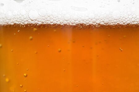 beer with foam and bubbles backgroundの写真素材