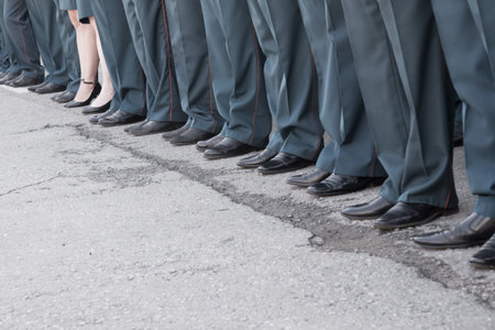 Row of legs on parade in uniform