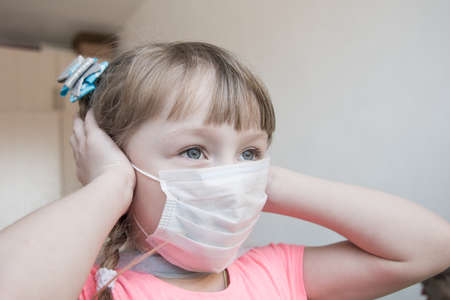 five-year-old girl in a medical maskの写真素材