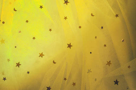 Soft focus fabric yellow sequins.の写真素材