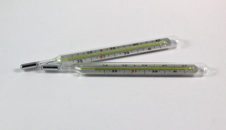 two medical thermometers on a white background