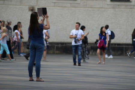 Happy young woman taking selfie. Woman taking selfie photo with a smarphone in the cityのeditorial素材