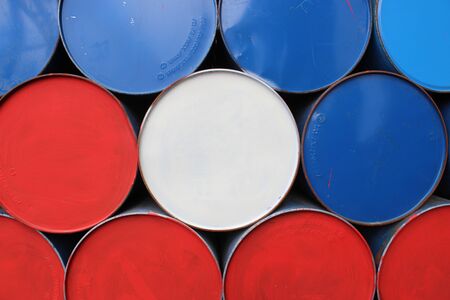 Oil tanks, white, red and blue chemical tanks stacked horizontallyの写真素材