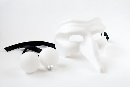 White Christmas toys and Venetian mask on a white backgroundの写真素材
