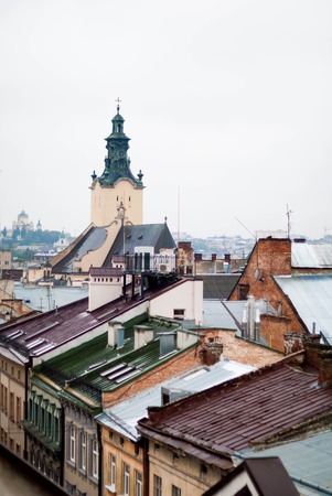 Red tiled roofs in the misty city in Europe.の写真素材