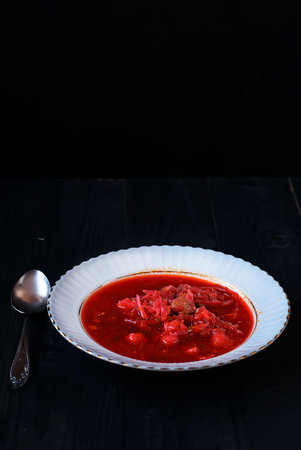 Ukrainian borscht on a black background in a white plateの写真素材