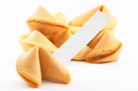 Chinese fortune cookies, on white background, with a white piece of paper for entering own text/fortune, shallow depth of fieldの写真素材