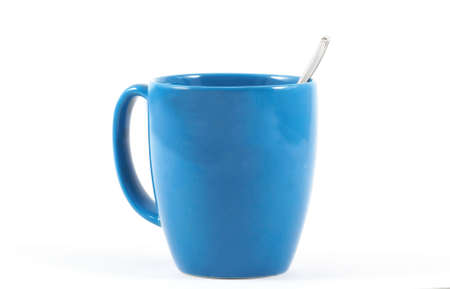 Blue coffee mug with spoon side view on isolated white background, horizontal orientationの写真素材