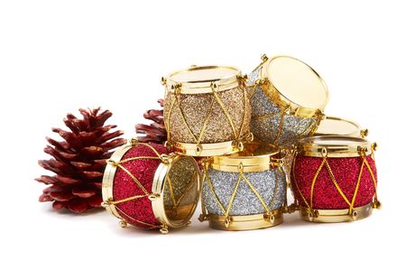 Christmas decoration, red, silver & gold drums, pine cones, isolated on white background. Horizontal, landscape orientation.の写真素材