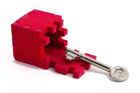 Key with a cube puzzle. Concept of solving problems. Isolated on white background.の写真素材
