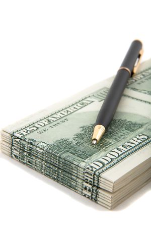 Pen on top of a stack of cash, indicate agreement, deals, businesses involving cash and financesの写真素材
