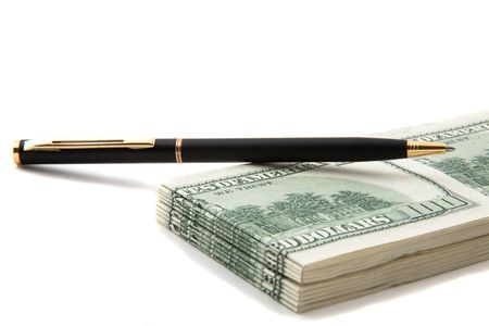 Pen on top of a stack of cash, indicate agreement, deals, businesses involving cash and financesの写真素材