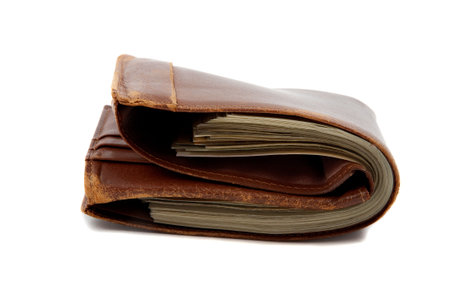 Wallet full of money, lying down on white