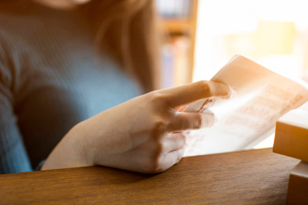 Hand of young girl student holding a book to reading at library, Education concept
の写真素材