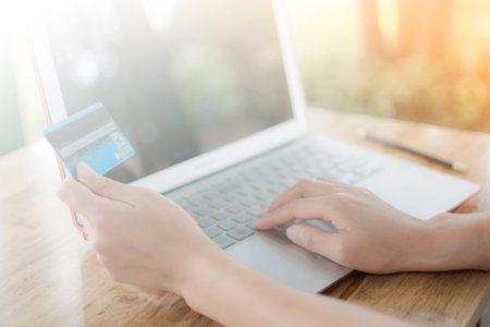 Woman holding credit card to pay for purchase the product on the shopping online internet of laptop