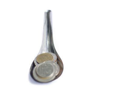 Isolate full pile of Thai coin on silver spoon with white backgroundの写真素材