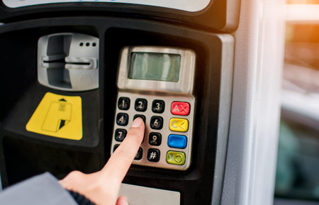 Woman finger woman pressing the button to paying car parking meter
