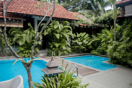 Blue water swimming pool with green trees landscapeのeditorial素材