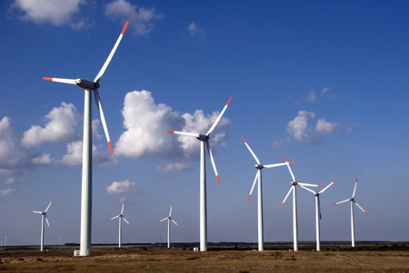 Row of wind turbines in front of blue sky
