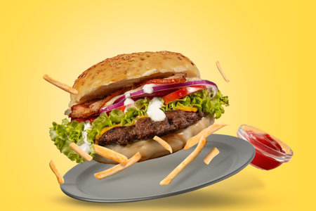 <p _msttexthash="4685642" _msthash="3363">A hamburger falling on a plate with french fries and ketchup on a friendly background</p>の写真素材