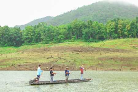 Fishermans standing in small boat on river at Mae Ngud Dam,Chiang Mai city, ThaiLand on August 2,2015.のeditorial素材