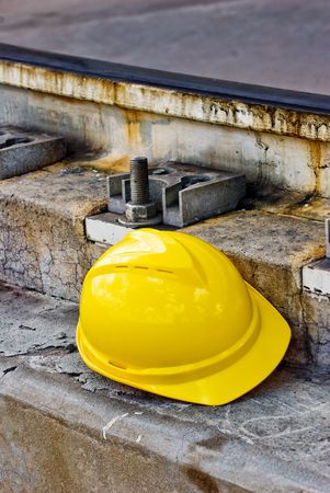 A bright yellow hard hat on a platform of a hard hat area.の写真素材
