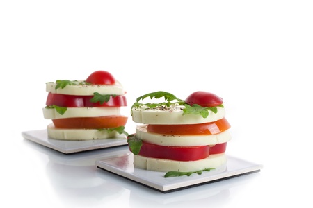 A light snack of cheese, tomato, and rocket saladの写真素材