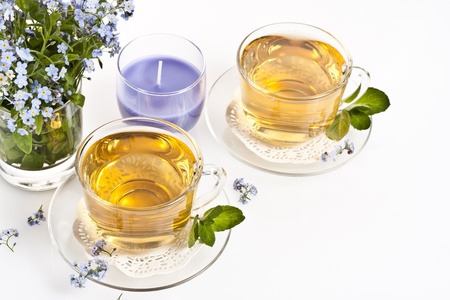 Two cup of fresh herbal tea in the backgroundの写真素材