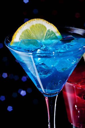 Two colorful cocktails over starry black backgroundの写真素材