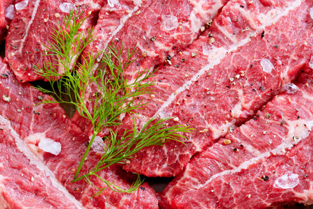 Raw marbled beef with spice - closeup
