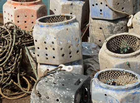 A stack of whelk pots with several coils of ropeの写真素材