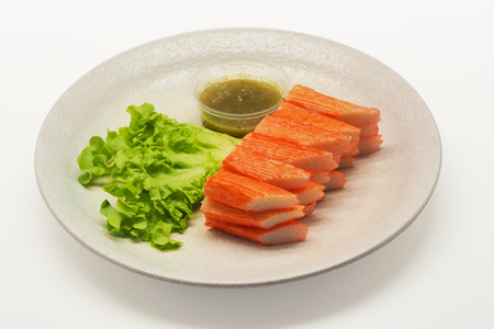crab stick serve with spicy sauce on white backgroundの写真素材