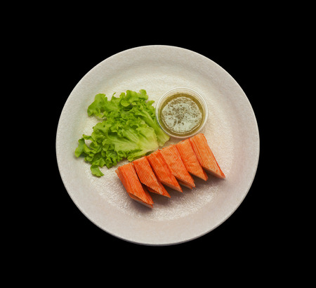 crab stick serve with spicy sauce on black backgroundの写真素材