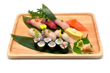 Mixed sushi set in brown wooden tray on white backgroundの写真素材