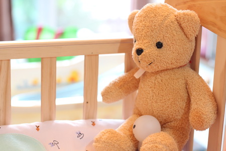 Teddy bears sit in child bedの写真素材