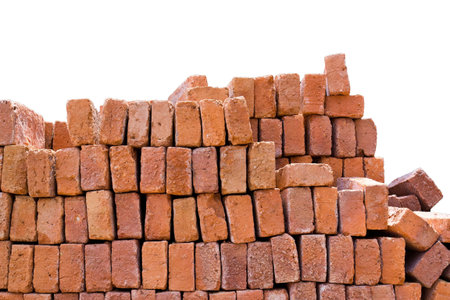 A stack of red clay bricks isolated on a white background