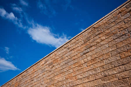 Brick wall, blue sky backgroundの写真素材