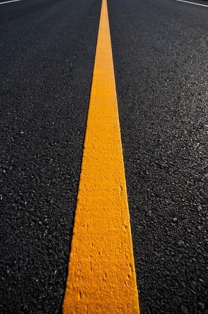 Asphalt road with separation yellow linesの写真素材