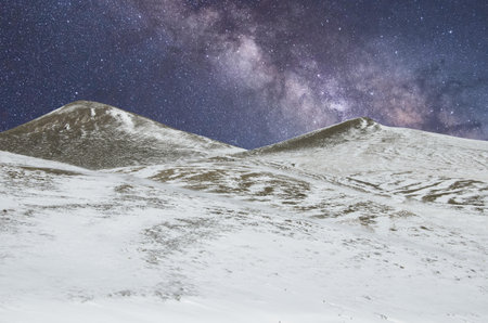View of starry sky over snowy mountains in the Umbria region, Italyの写真素材