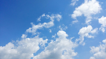 bright blue sky with puffy white clouds.