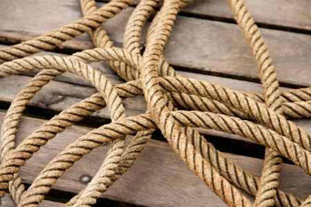 a pile of tangle braided ropes on the wood floor