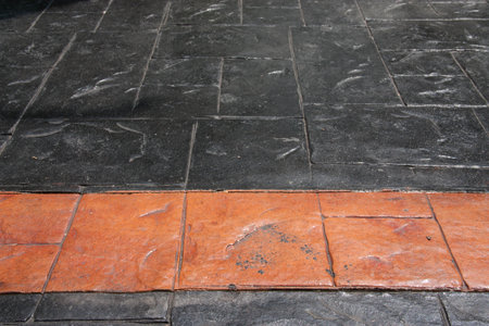 black stone floor with orange stone line
