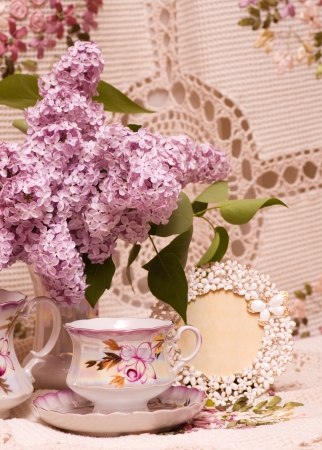 Vintage teacup with spring flowers lilacの写真素材