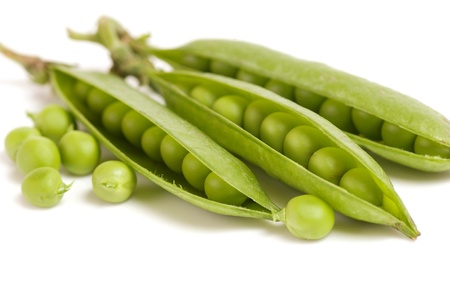 fresh green peas isolated on a white backgroundの写真素材