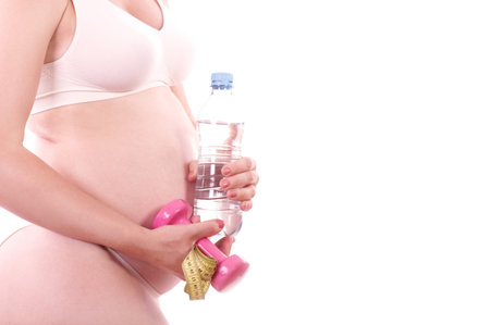 Pregnant woman with water and dumb-bell