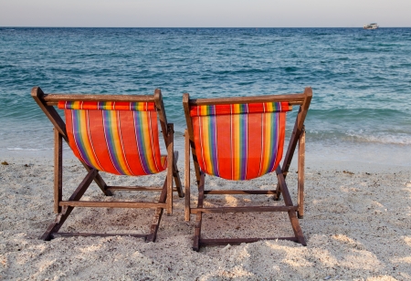 beach chairs on white sand in Thailandの写真素材