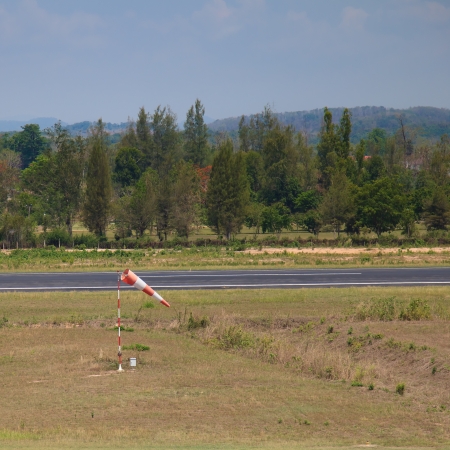 orange-white stripe wind sock in the airportの写真素材