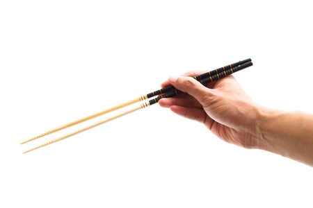 Hand holding chopsticks, isolated on white background.の写真素材