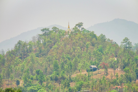 Buddhist temple with pagoda in forest at the mountain. Omkoi, Chiang Mai, Thailand.の写真素材