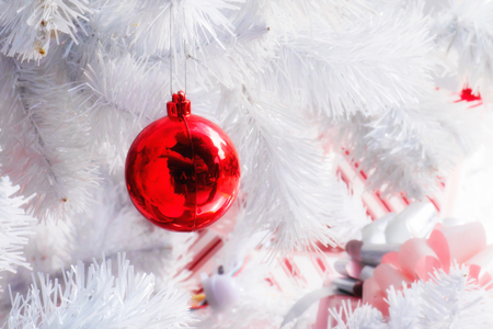 Decorated White Christmas tree with red ball and gift box.の写真素材